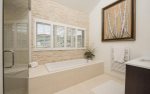 En-suite master bathroom with Jacuzzi tub and walk-in shower.